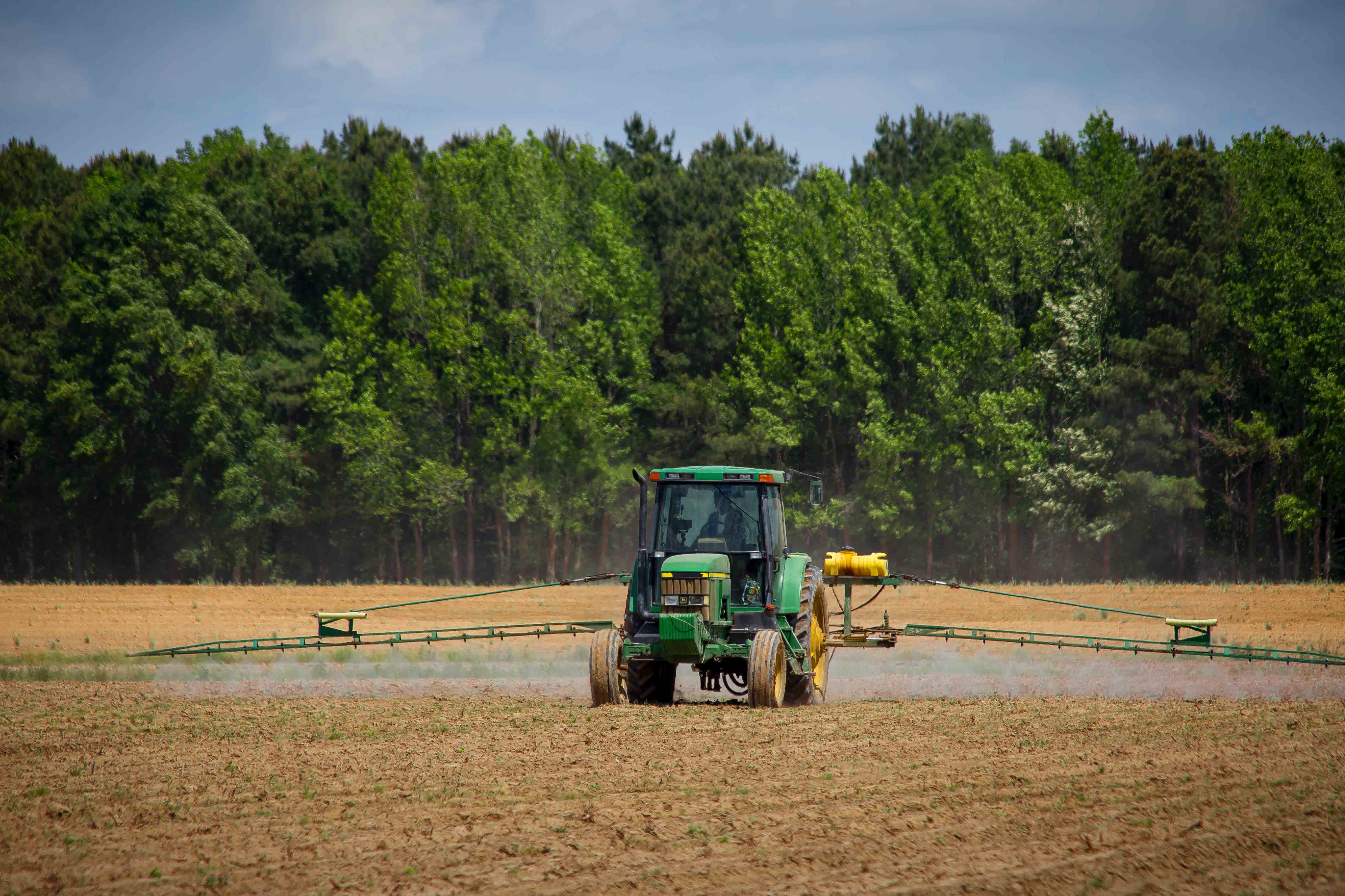 Tractor spraying field